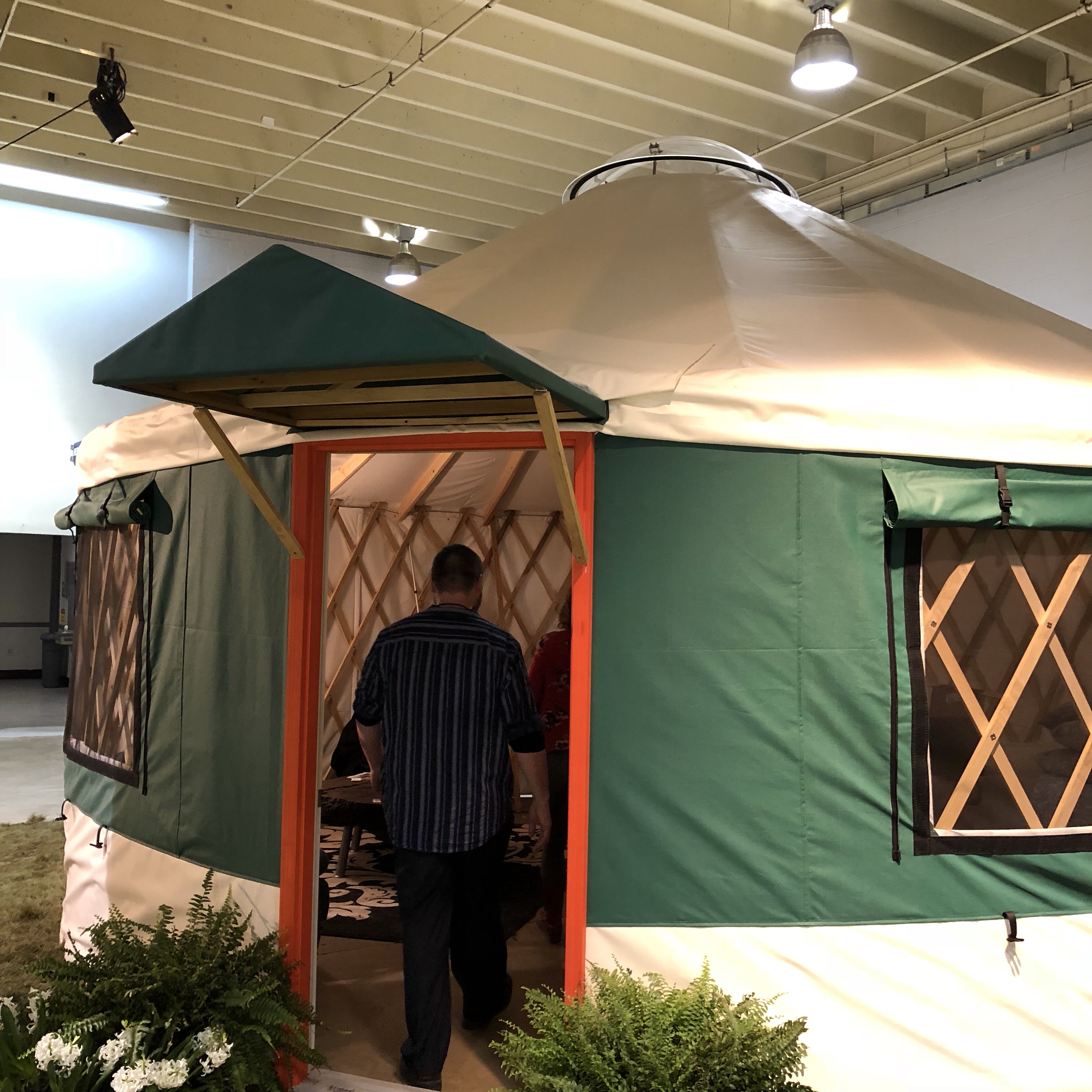 Yurt at the garden show, with Rick getting ready to break it down.